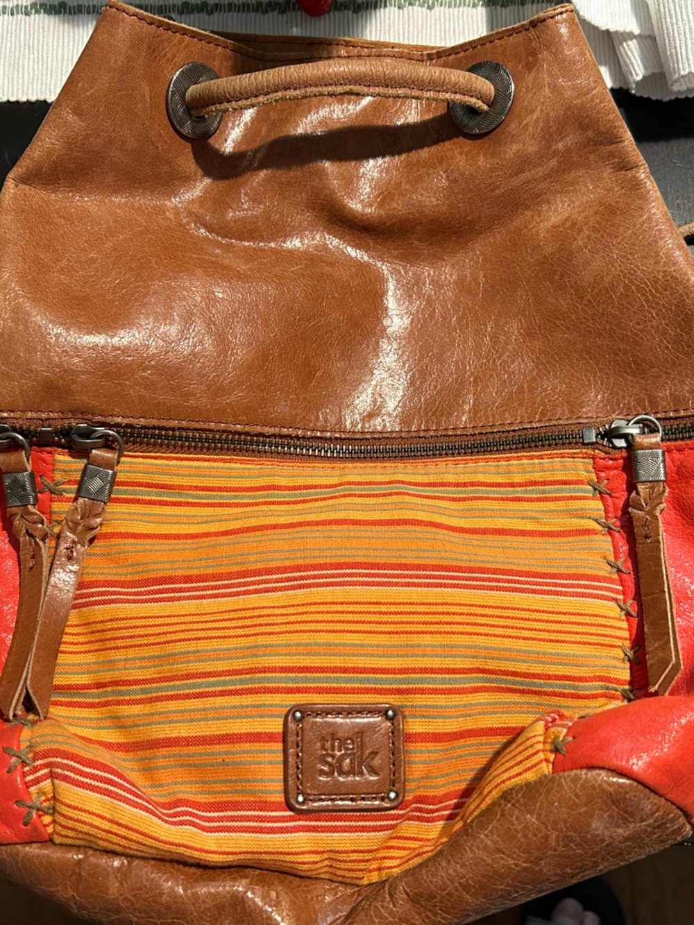 The Sak Brown Leather Drawstring Shoulder Bag with Orange Accents